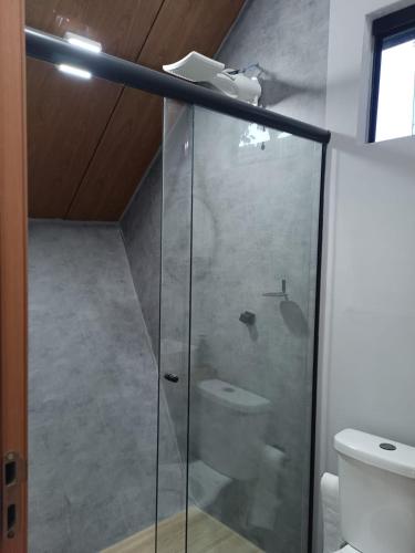 a bathroom with a glass shower with a toilet at Kabana Harmony in Aquidauana