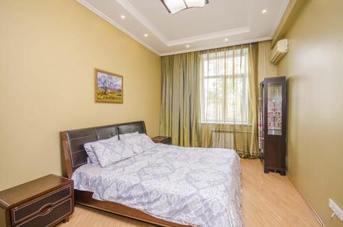 a bedroom with a bed and a window at Abylai Khan 113 Central in Almaty