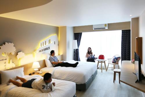 Ένα ή περισσότερα κρεβάτια σε δωμάτιο στο Hatyai Signature Hotel