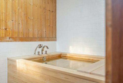 a bathtub with a wooden floor in a bathroom at Yangpyeong Narinsoom Private Villa in Yangpyeong