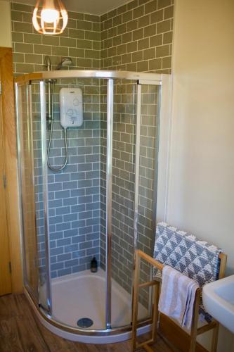 a bathroom with a shower and a sink at Tate's Meadow in Banbridge