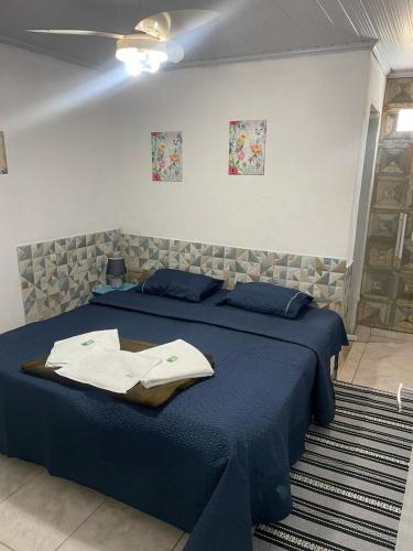 a bedroom with two beds with blue sheets at Pousada Chuá Chuá in Conservatória