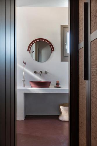 a bathroom with a sink and a mirror at Seriphos Estate in Serifos Chora