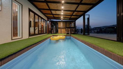 an indoor swimming pool with a house at Yeongheungdo Stay Noc Pool Villa in Incheon