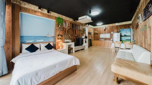 a bedroom with a bed and a view of the ocean at Ganghwado Babavelley Pension in Incheon