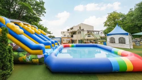 a water park with a slide and a pool at Ganghwado Babavelley Pension in Incheon