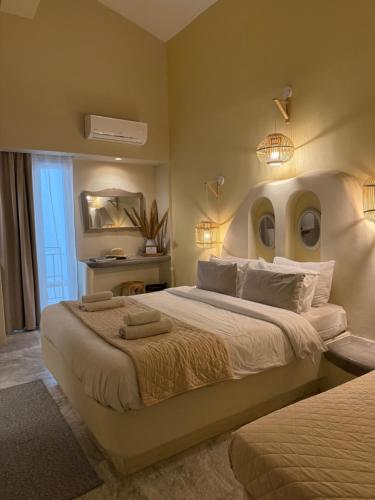 a bedroom with a large bed with a face on the wall at Fratelli Family Rooms in Tinos