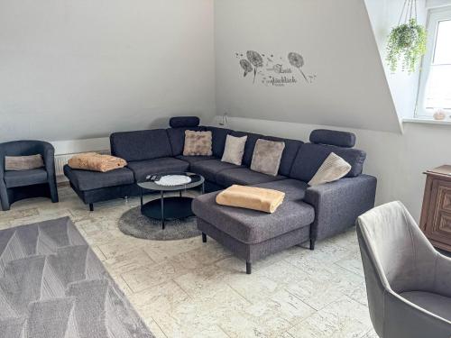 a living room with a blue couch and chairs at Apartment Marianne by Interhome in Hooksiel