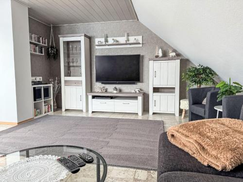 a living room with a couch and a flat screen tv at Apartment Marianne by Interhome in Hooksiel