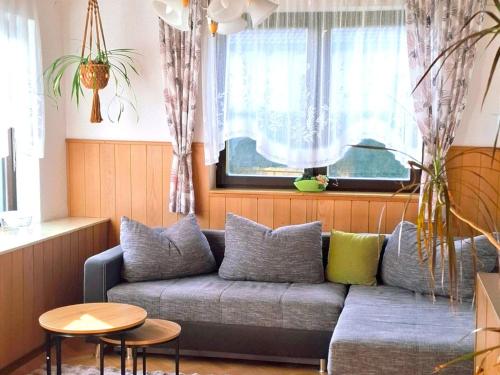 a living room with a couch and a table at Holiday Home Katharina by Interhome in Gröbming