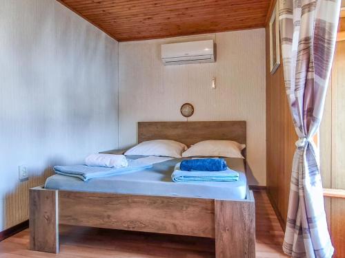 a bed with two pillows on it in a room at Holiday Home Delfar by Interhome in Nerezine