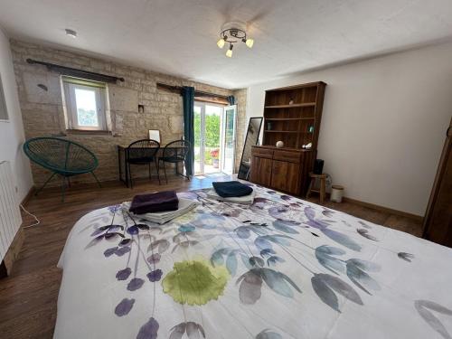a bedroom with a large bed in a room at Esprit Charentais - The Byre in Londigny