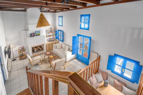 a living room with blue accents on the walls at Villa Cleio where the sea meets absolute calm in Skiathos