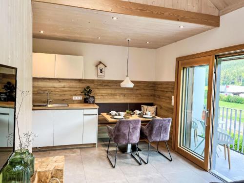 a kitchen with a table and chairs in a room at Apartment Kinast - HFT202 by Interhome in Hofstetten