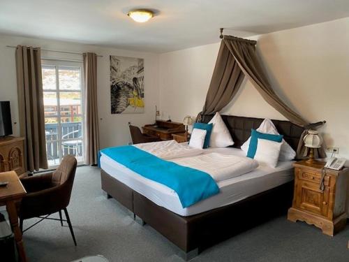 a bedroom with a large bed with a canopy at Schlosshotel Landstuhl in Landstuhl