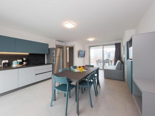 a kitchen and dining room with a table and chairs at Apartment Nashira-5 by Interhome in Lignano Sabbiadoro
