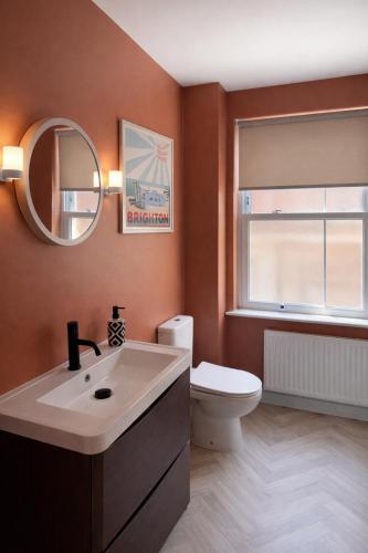 a bathroom with a sink and a toilet and a mirror at The Distillery Room in Scarborough