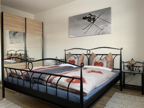 a bedroom with a bed with a black frame at Ferienwohnung Horizont in Ofterschwang