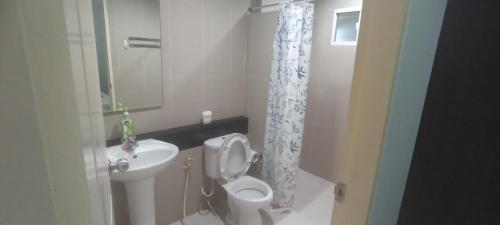 a bathroom with a white toilet and a sink at Wilfrid villa in Hua Hin