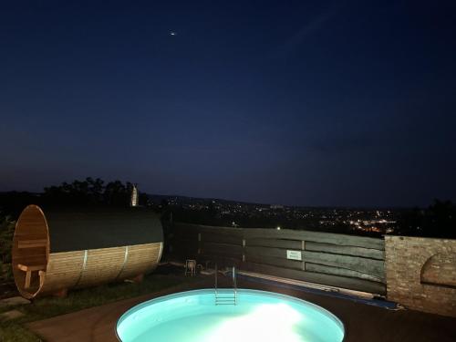 a bath tub on top of a building at night at Villa della Vita in Pécs