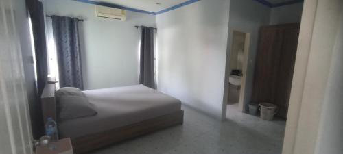 a small bedroom with a bed and a bathroom at Wilfrid villa in Hua Hin