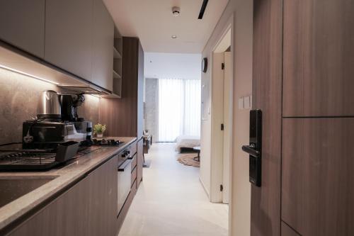 a kitchen with a sink and a counter top at Stylish modern studio near Miracle Garden with Gym, Pool and Padel court in Dubai