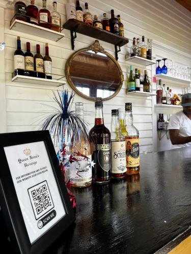 a bar with bottles of alcohol on a counter at Queen Anne's Revenge in Bar Harbor