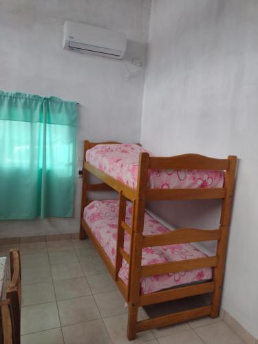 a room with two bunk beds in a room at La Casita de Junín in Junín