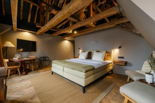 a bedroom with a large bed and a desk at Hotel 1635 in Haarlem