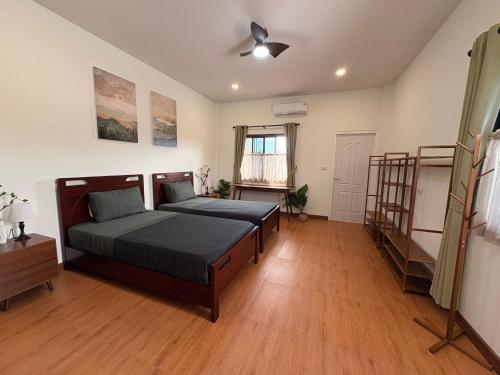 a bedroom with a bed and a ceiling fan at Nong Hoi Nest, New Townhome with Positive Pressure Air Purifier in Chiang Mai