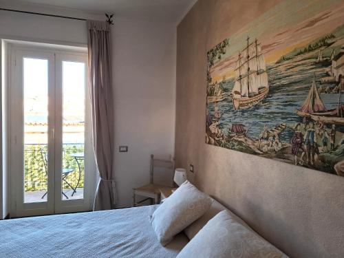 a bedroom with a large painting on the wall at Da Ghjuannedda in Arzachena