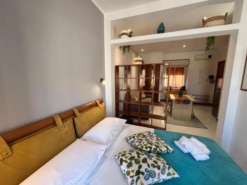 a bedroom with a bed with two pillows on it at Teatro Massimo - Apartment with a View of Theater Massimo in Palermo