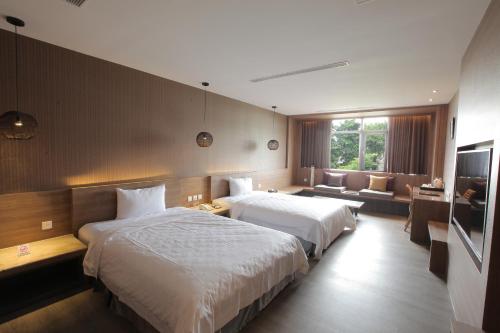 Postel nebo postele na pokoji v ubytování Imperial Dynasty Boutique Hotel