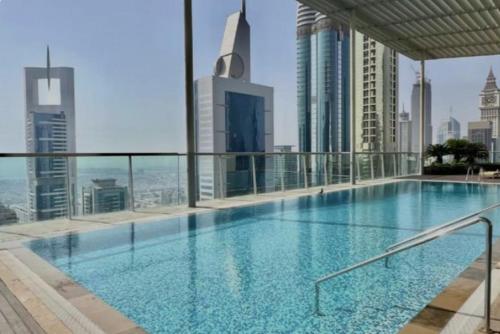 a swimming pool on the roof of a building at Nasma Luxury Stays - White Haven Studio With Charming Cityscape Views in Dubai