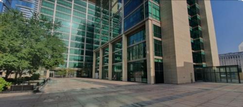 a large glass building with a lot of windows at Nasma Luxury Stays - White Haven Studio With Charming Cityscape Views in Dubai