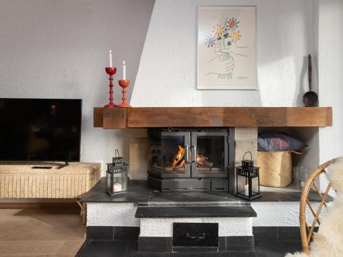 a living room with a fireplace and a couch at Apartment Entremont 60 by Interhome in Verbier