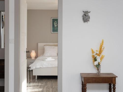 a bedroom with a white bed and a table at Apartment Stem 2 by Interhome in Verbier