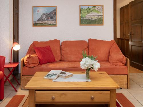 a living room with a couch and a coffee table at Apartment Centaure B RS 2 by Interhome in Ovronnaz
