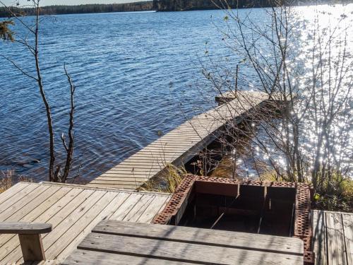 a wooden dock next to a body of water at Holiday Home Putilanranta by Interhome in Saapunki