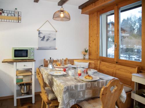 a dining room with a table with food on it at Apartment Beau Site No 21 by Interhome in Ovronnaz