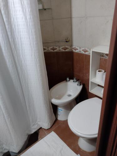 a bathroom with a toilet and a sink at Casita Tafí del Valle in Tafí del Valle