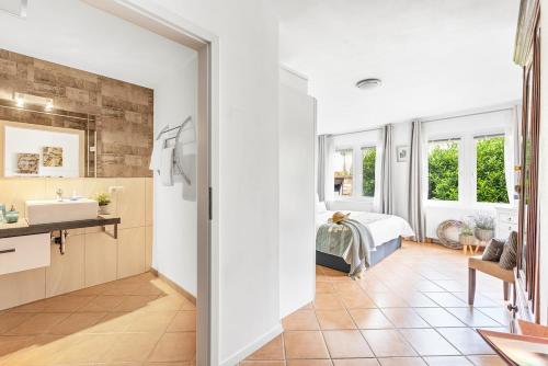 a bathroom with a sink and a bed in a room at Landhaus Sofie in Kreischa