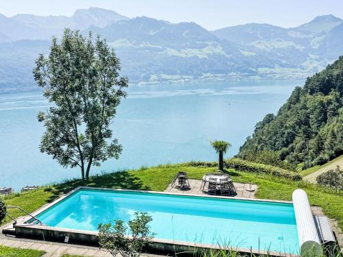 a swimming pool with a view of a lake at Apartment Platten by Interhome in Gersau