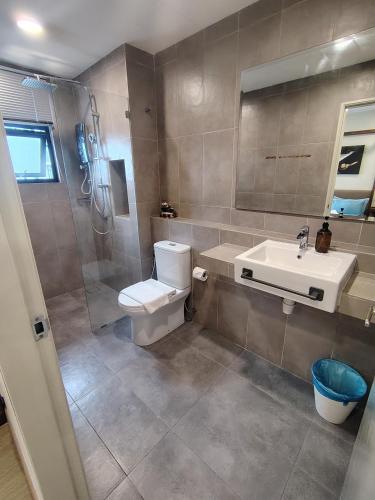 a bathroom with a toilet and a sink and a shower at Timurbay Seafront By Moonlight Sea & Poolview in Kuantan