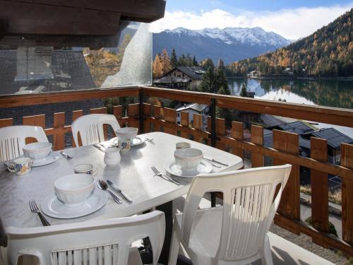 a table on a balcony with a view of a lake at Apartment Parc B 431 by Interhome in Champex