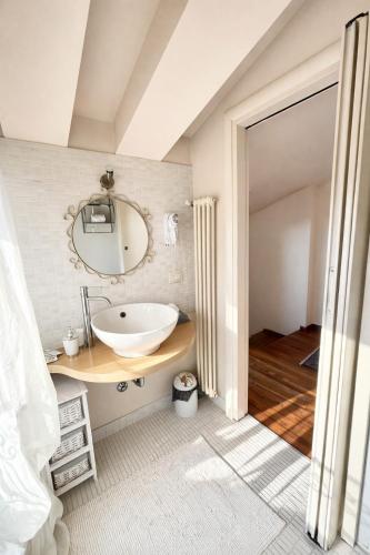 a bathroom with a sink and a mirror at La Suite del Centro in Lazise