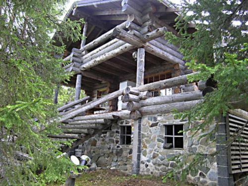 a log cabin in the middle of a forest at Holiday Home Rantapuro by Interhome in Joutsenniemi