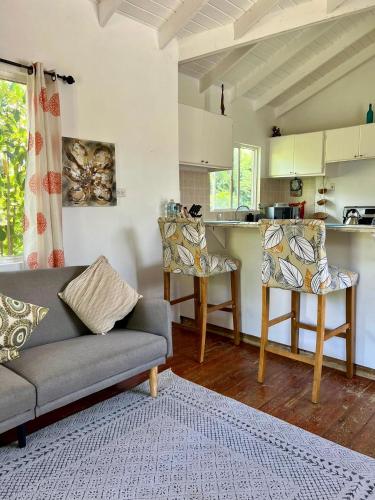 un soggiorno con divano e sedie e una cucina di The Tree House - by ZenBreak a Saint George
