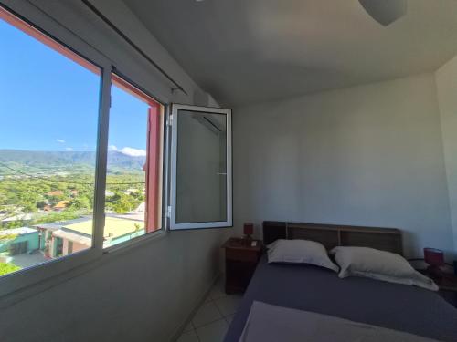 a bedroom with a bed and a large window at Au Franciscea, climatiseurs, centre ville, sud in Saint-Louis