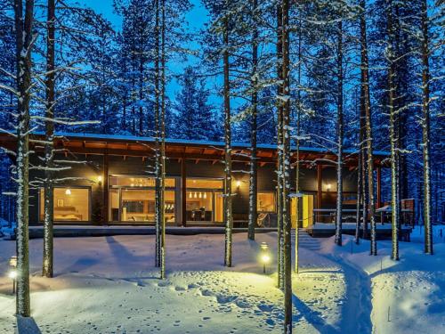 a house in the woods in the snow at Holiday Home Koukunmaja by Interhome in Kuusamo